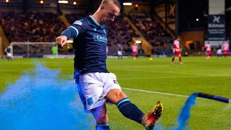 DUNDEE, SCOTLAND - SEPTEMBER 22: Dundee's Leigh Griffiths kicks a blue smoke bomb thrown on by St Johnstone fans during a Premier Sports Cup quarter-final match between Dundee and St Johnstone at the Kilmac Stadium at Dens Park, on September 22, 2021, in Dundee, Scotland. (Photo by Ross Parker / SNS Group)