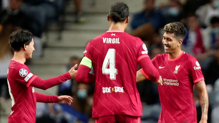 Liverpool's Roberto Firmino, right, celebrates after scoring his side's fifth goal during the Champions League group B soccer match between FC Porto and Liverpool at the Dragao stadium 