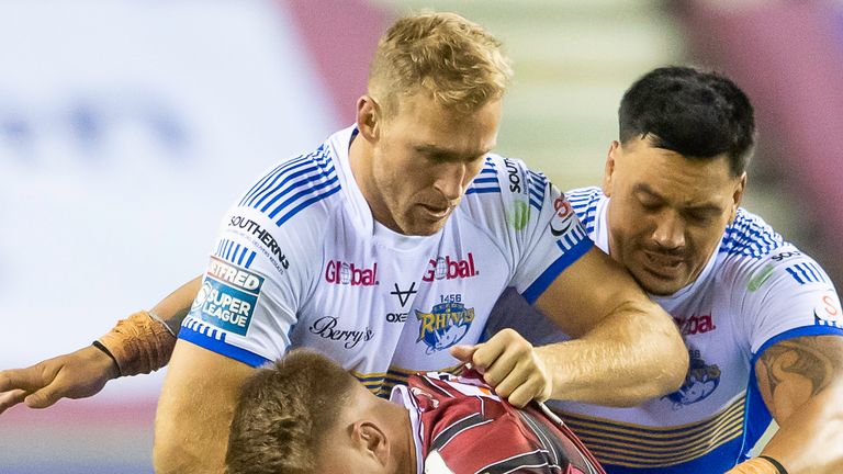 Picture by Allan McKenzie/SWpix.com - 23/09/2021 - Rugby League - Betfred Super League Playoffs - Eliminator Game 1 - Wigan Warriors v Leeds Rhinos - DW Stadium, Wigan, England - WIgan's Morgan Smithies is tackled by Leeds's Matt Prior, Zane Tetevano & Rhys Martin.