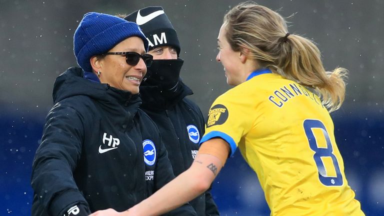 Megan Connolly celebrates with Brighton manager Hope Powell after her winning goal