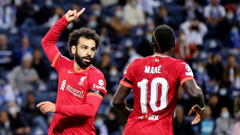 Liverpool's Mohamed Salah, center, celebrates after scoring the opening goal during the Champions League group B soccer match between FC Porto and Liverpool at the Dragao stadium 