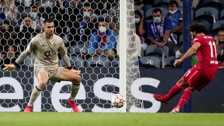 Liverpool's Mohamed Salah, right, scores his side's third goal during the Champions League group B soccer match between FC Porto and Liverpool at the Dragao stadium