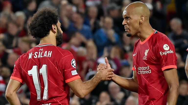 Mohamed Salah, left, celebrates with Fabinho after scoring Liverpool's second goal against AC Milan
