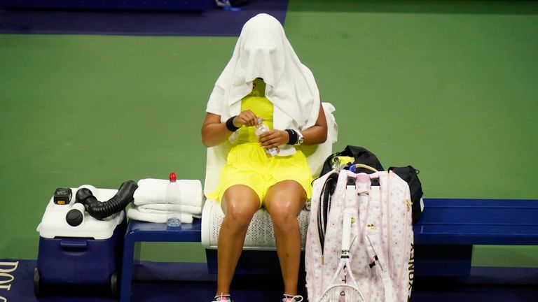 AP - Naomi Osaka, of Japan, covers her head between games against Leylah Fernandez, of Canada, at the third round of the US Open tennis championships, Friday, Sept. 3, 2021, in New York. (AP Photo/Frank Franklin II)