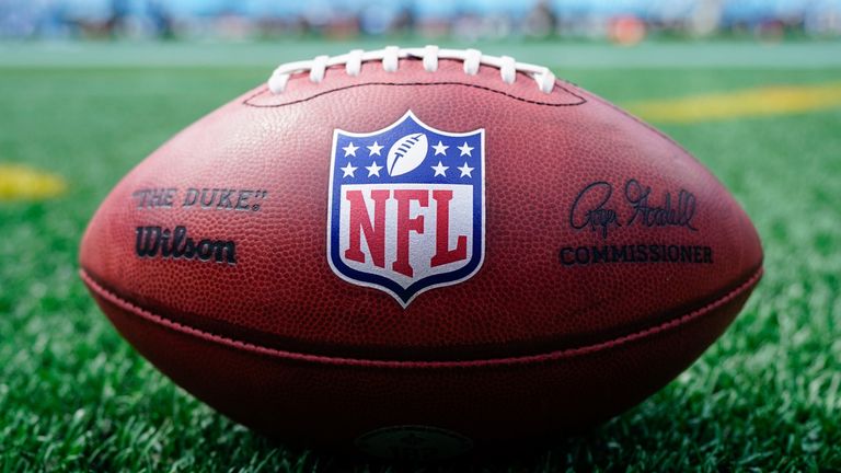 An NFL football with logo sits on the field before an NFL football game between the Carolina Panthers and the New Orleans Saints Sunday, Sept. 19, 2021, in Charlotte, N.C. (AP Photo/Jacob Kupferman)