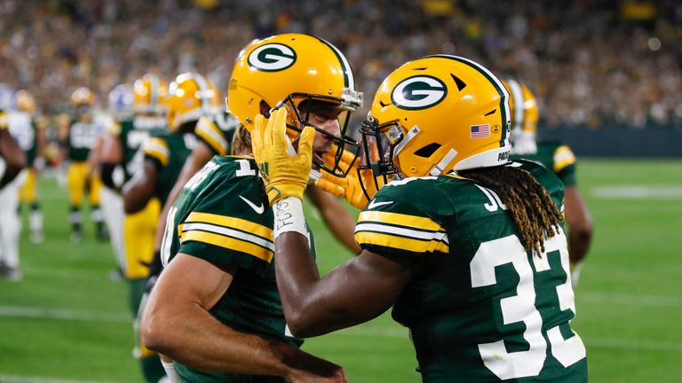 Green Bay Packers&#39; Aaron Jones is congratulated by Aaron Rodgers after running for a touchdown during the first half of an NFL football game against the Detroit Lions Monday, Sept. 20, 2021, in Green Bay, Wis