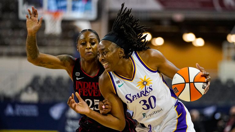 Los Angeles Sparks forward Nneka Ogwumike (30) drives on Indiana Fever guard Tiffany Mitchell (25) in the first half of a WNBA basketball game in Indianapolis, Tuesday, Aug.  31, 2021. (AP Photo/Michael Conroy)