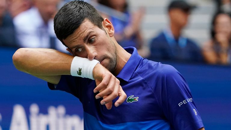 Novak Djokovic, of Serbia, wipes sweat from his face between serves from Daniil Medvedev, of Russia, during the men...s singles final of the US Open tennis championships, Sunday, Sept. 12, 2021, in New York. (AP Photo/Elise Amendola) 