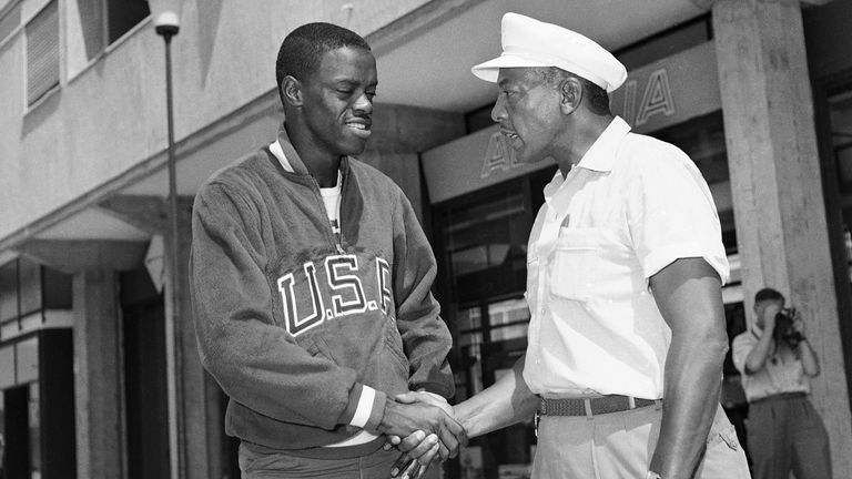 U.S. Jesse Owens, for twenty-three years the world broad jump record man, shakes hands with U.S. Ralph Boston in the Olympic village in Rome on Sept. 1, 1960, who broke Jesse Owens’s record and will try to also get the Olympic gold medal.