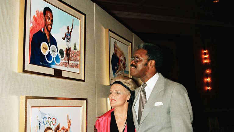 Pat McCormick, left, and Ralph Boston pose near artwork at the Olympic hall fame in New York, December 13, 1985.