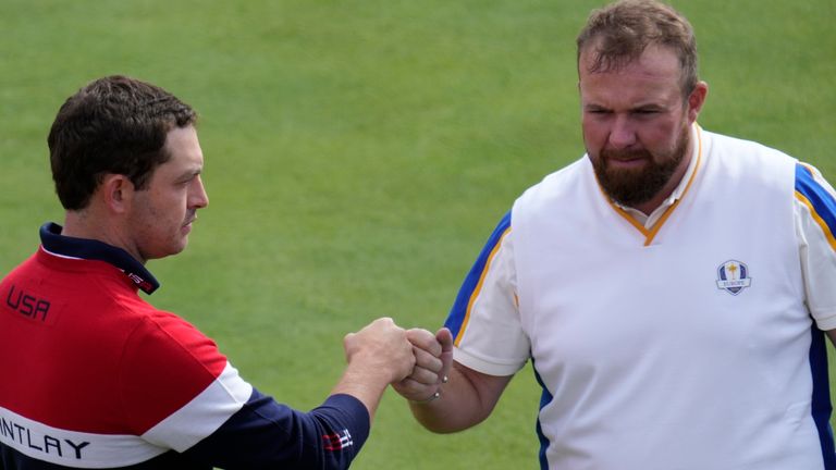 Team USA's Patrick Cantlay greets Team Europe's Shane Lowry on the first tee during a singles match the Ryder Cup at the Whistling Straits Golf Course Sunday, Sept. 26, 2021, in Sheboygan, Wis. (AP Photo/Ashley Landis)