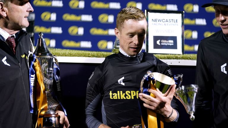 Team talkSPORT&#39;s Jack Mitchell holds the Racing League trophy