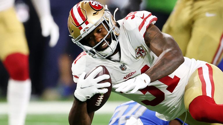 San Francisco 49ers running back Raheem Mostert stiff-arms Las