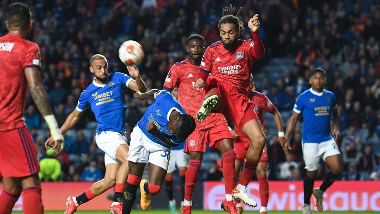 SNS - GLASGOW, SCOTLAND - SEPTEMBER 16: Lyon's Jason Denayer (R) clears the ball away from Rangers' Fashion Sakala during a UEFA Europa League group stage match between Rangers and Lyon, on September 16, 2021, in Glasgow, Scotland.  (Photo by Craig Foy / SNS Group)