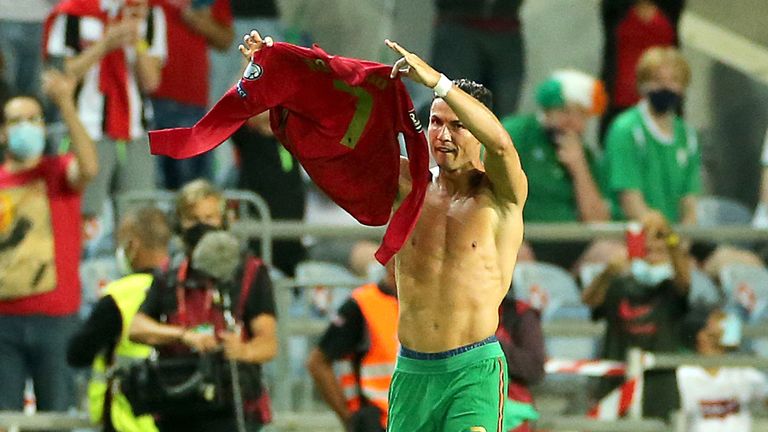 Portugal&#39;s Cristiano Ronaldo holds up his shirt to to the fans after scoring his sides second goal during the 2022 FIFA World Cup Qualifying match