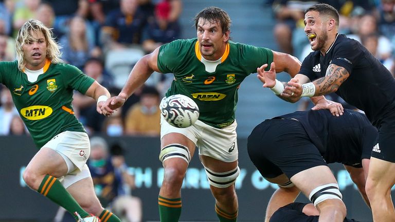 New Zealand's TJ Perenara, right, passes the ball as South Africa's Faf de Klerk, left, and Eben Etzebeth watch during the Rugby Championship