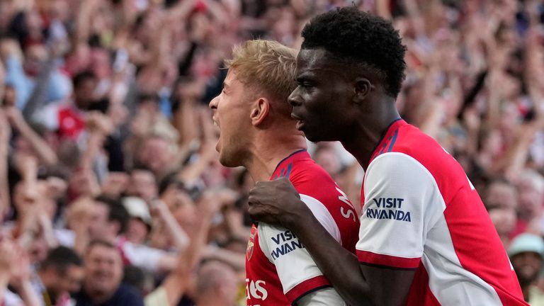 Arsenal&#39;s Emile Smith Rowe, left, celebrates with Arsenal&#39;s Bukayo Saka after scoring his side&#39;s opening goal during the English Premier League soccer match between Arsenal and Tottenham Hotspur at the Emirates stadium in London, Sunday, Sept. 26, 2021. (AP Photo/Frank Augstein)