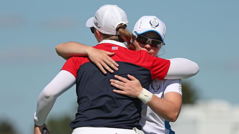 Leona Maguire of Team Europe hugs Jennifer Kupcho of Team USA after winning a point and her match during the Singles Match on day three of the Solheim Cup