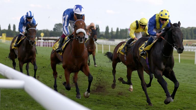 Solid Stone ridden by William Buick (right) wins The Dubai Duty Free Legacy Cup Stakes at Newbury