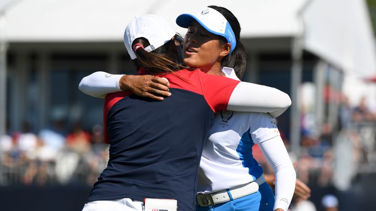 United States' Mina Harigae gets hugged after being defeated by Europe's Celine Boutier on the 14th hole during the singles matches at the Solheim Cup