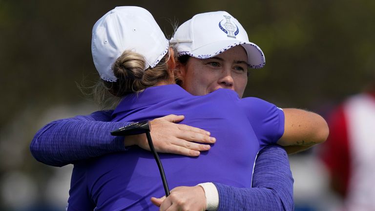 Europe's Mel Reid and Leona Maguire hug on the 18th hole after their win foursome matches at the Solheim Cup