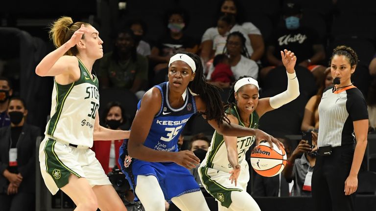 Jordin Canada of the Seattle Storm steals the ball from Jonquel Jones of the Connecticut Sun as Storm teammate Breanna Stewart defends during the 2021 Commissioner's Cup Championship Game