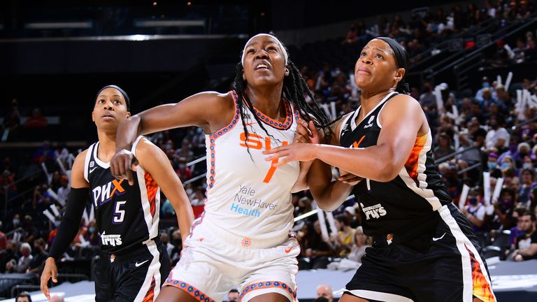 Beatrice Mompremier #1 of the Connecticut Sun and Kia Vaughn #1 of the Phoenix Mercury fight for position during the game on September 11, 2021 at Footprint Center in Phoenix, Arizona. 