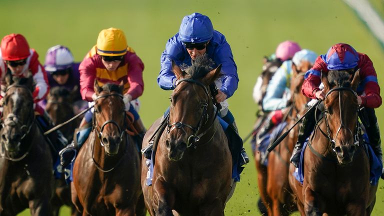 NEWMARKET, ENGLAND - OCTOBER 09: William Buick riding Native Trail (C, blue) win The Darley Dewhurst Stakes at Newmarket Racecourse on October 09, 2021 in Newmarket, England. (Photo by Alan Crowhurst/Getty Images)