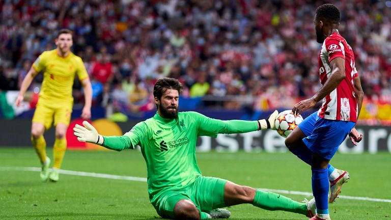 Liverpool goalkeeper Alisson made three saves against Atletico Madrid, including this one to keep out Thomas Lemar                               