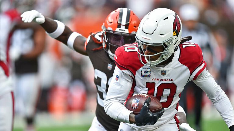 Arizona Cardinals wide receiver DeAndre Hopkins (10) scores a 13-yard touchdown as Cleveland Browns defensive back Ronnie Harrison cannot make a tackle during the first half of an NFL football game Sunday, Oct. 17, 2021, in Cleveland. (AP Photo/David Richard)