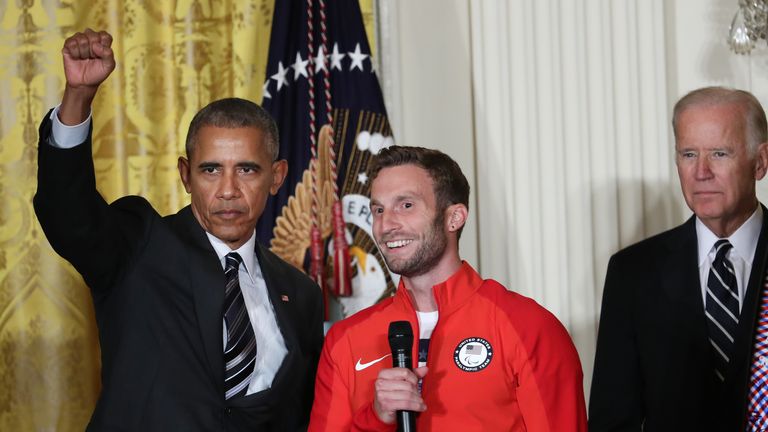 President Barack Obama raised his fist as he praised Smith and Carlos alongside US Olympians and Paralympians at the White House in 2016.