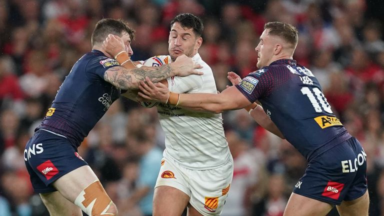 Catalans Dragons' Ben Garcia (centre) is tackled by St Helens' Mark Percival (left) and St Helens' Matty Lees (right) during the Betfred Super League grand final at Old Trafford, Manchester. Picture date: Saturday October 9, 2021. See PA story RUGBYL Final. Photo credit should read: Martin Rickett/PA Wire. RESTRICTIONS: Use subject to restrictions. Editorial use only, no commercial use without prior consent from rig