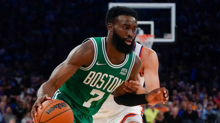 Boston Celtics' Jaylen Brown (7) drives past New York Knicks' Evan Fournier during the second half of an NBA basketball game Wednesday, Oct. 20, 2021, in New York. The Knicks won 138-134. (AP Photo/Frank Franklin II)