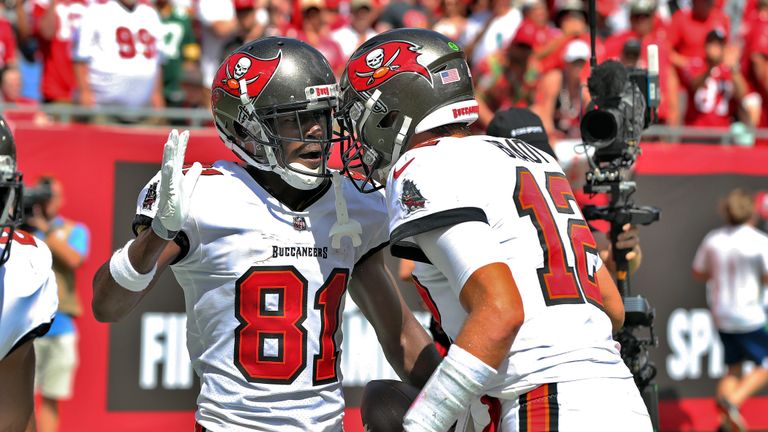 Tampa Bay Buccaneers wide receiver Antonio Brown (81) celebrates his 62-yard touchdown reception with quarterback Tom Brady (12) during the first half of an NFL football game against the Miami Dolphins Sunday, Oct. 10, 2021, in Tampa, Fla.