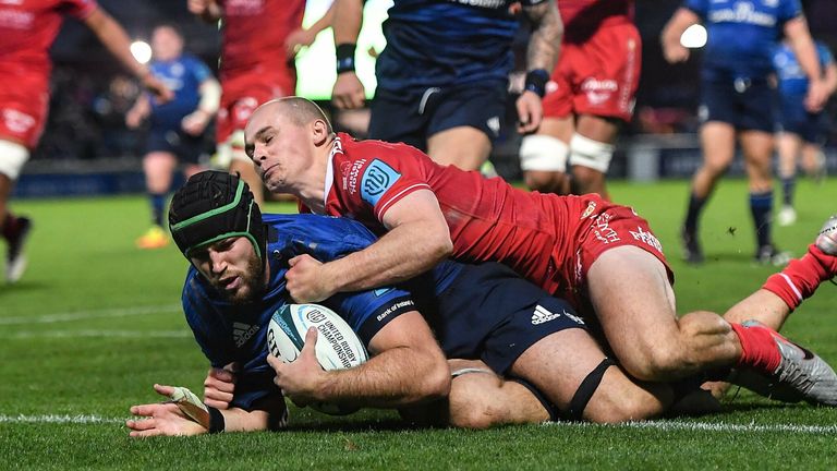 16 October 2021; Caelan Doris of Leinster dives over to score his side's fourth try, despite the tackle of Scarlets' Ioan Nicholas, during the United Rugby Championship match between Leinster and Scarlets at the RDS Arena in Dublin. Photo by Seb Daly/Sportsfile