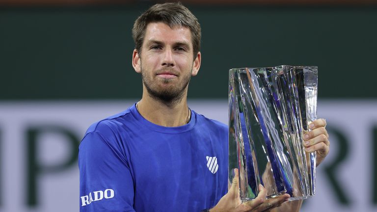 Cameron Norrie of Great Britain holds his winners trophy after his three set victory against Nikoloz Basilashvili of Georgia in the men&#39;s final match on Day 14 of the BNP Paribas Open at the Indian Wells Tennis Garden on October 17, 2021 in Indian Wells, California. (Photo by Clive Brunskill/Getty Images)