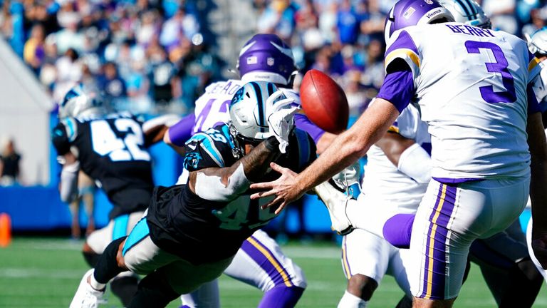 Carolina Panthers linebacker Frankie Luvu (49) blocks the punt of Minnesota Vikings punter Jordan Berry (3) during the second half of an NFL football game, Sunday, Oct. 17, 2021, in Charlotte, N.C. Carolina Panthers safety Kenny Robinson picked up the ball for a touchdown. (AP Photo/Jacob Kupferman)