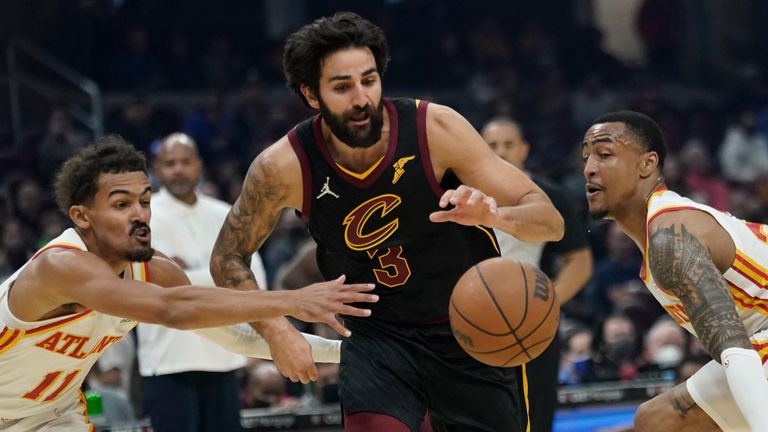 Cleveland Cavaliers&#39; Ricky Rubio drives between Atlanta Hawks&#39; Trae Young and John Collins