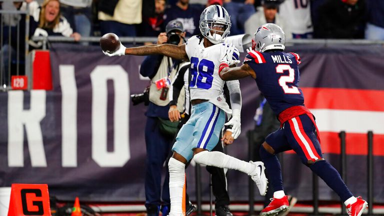 Dallas Cowboys wide receiver CeeDee Lamb (88) stretches the ball over the goal line for the game-winning touchdown, as New England Patriots cornerback Jalen Mills (2) gives chase, during overtime of an NFL football game, Sunday, Oct. 17, 2021, in Foxborough, Mass. (AP Photo/Michael Dwyer)