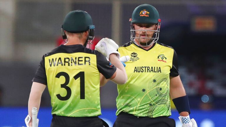Australia's captain Aaron Finch, right, and David Warner celebrate scoring runs during the Cricket Twenty20 World Cup match between Australia and Sri Lanka in Dubai, UAE, Thursday, Oct. 28, 2021. (AP Photo/Aijaz Rahi)..