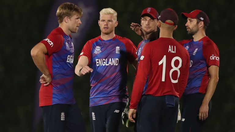 England's David Willey, left, celebrates with teammates the dismissal of India's Suryakumar Yadav during the Cricket Twenty20 World Cup warm-up match between India and England in Dubai