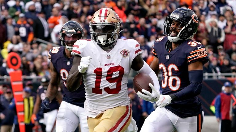 San Francisco 49ers wide receiver Deebo Samuel heads down the sideline past Chicago Bears linebacker Trevis Gipson (99) and defensive back DeAndre Houston-Carson for a big gain during the first half of an NFL football game 