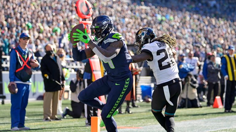 Seattle Seahawks&#39; DK Metcalf, left, turns into the end zone on a touchdown catch as Jacksonville Jaguars&#39; Shaquill Griffin defends during the first half of an NFL football game