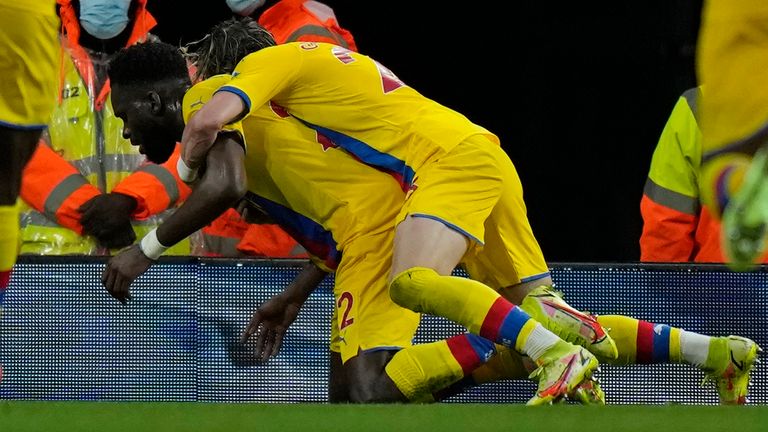 Crystal Palace's Odsonne Edouard, centre left, celebrates with team mates after scoring his side's second goal during an English Premier League soccer match between Arsenal and Crystal Palace at the Emirates Stadium in London, England, Monday Oct. 18, 2021. (AP Photo/Alastair Grant)