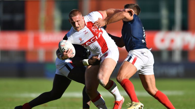 Mikolaj Oledzki of England drives for the line against France