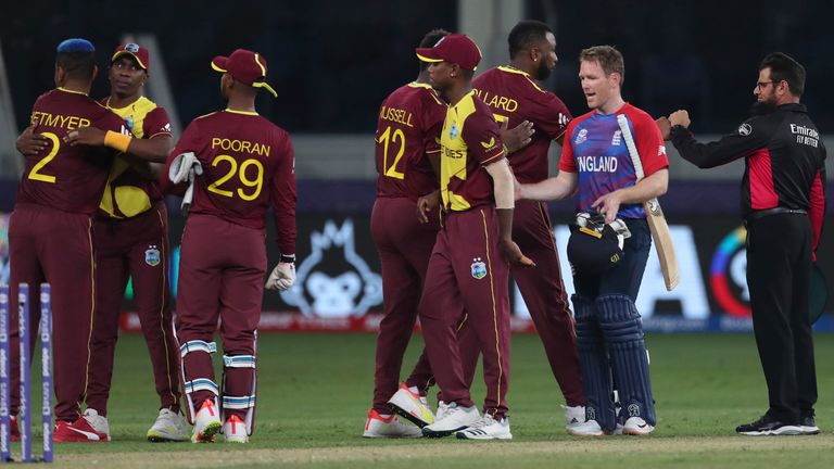 England&#39;s captain Eoin Morgan, second right shakes hands with members of the West Indies team after the end of the Cricket T20 World Cup match between England and the West Indies at the Dubai International Cricket Stadium, in Dubai