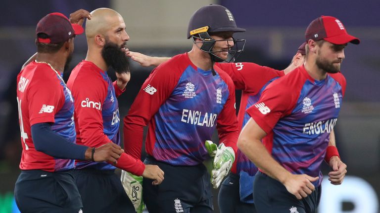 England&#39;s Moeen Ali, second left, celebrates with teammates after taking the wicket of West Indies&#39; Lendl Simmons caught by England&#39;s Liam Livingstone during the Cricket T20 World Cup match between England and the West Indies at the Dubai International Cricket Stadium, in Dubai