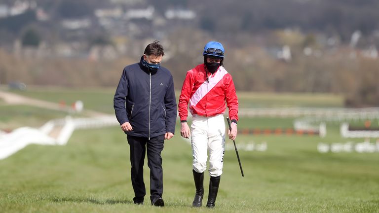 Trainer Henry de Bromhead walks back in with jockey Jack Kennedy after falling from Envoi Allen at Cheltenham in March