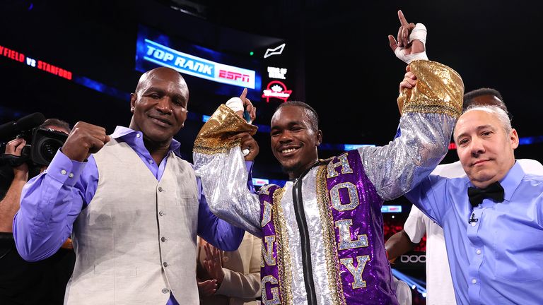 ATLANTA, GEORGIA - OCTOBER 23: Evander Holyfield (L) and Evan Holyfield (R) pose after the fight at State Farm Arena on October 23, 2021 in Atlanta, Georgia.(Photo by Mikey Williams/Top Rank Inc via Getty Images)
