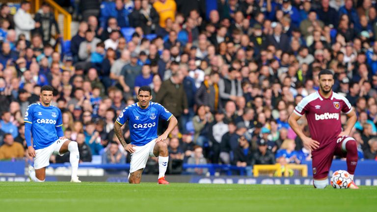 The players take a knee before kick-off at Goodison